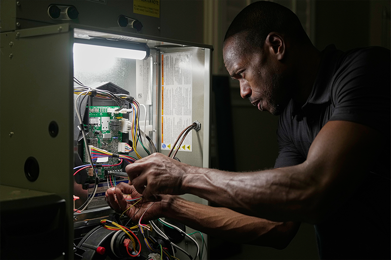 Trane rep fixing heating unit in basement