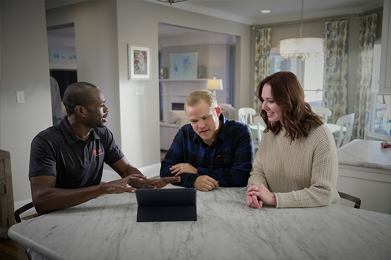 Trane rep with couple at marble table